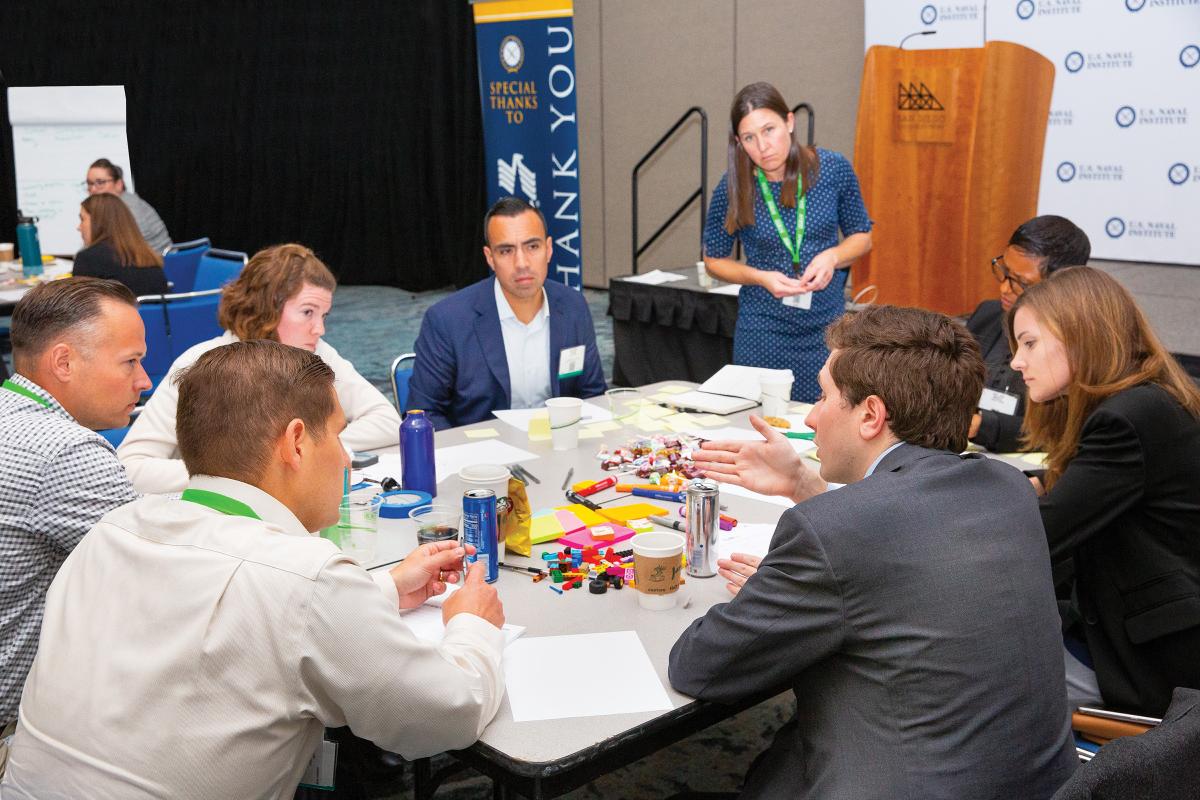 DARE participants are broken into groups and asked to brainstorm potential answers to two challenge questions posed by one of the Sea Service chiefs. 