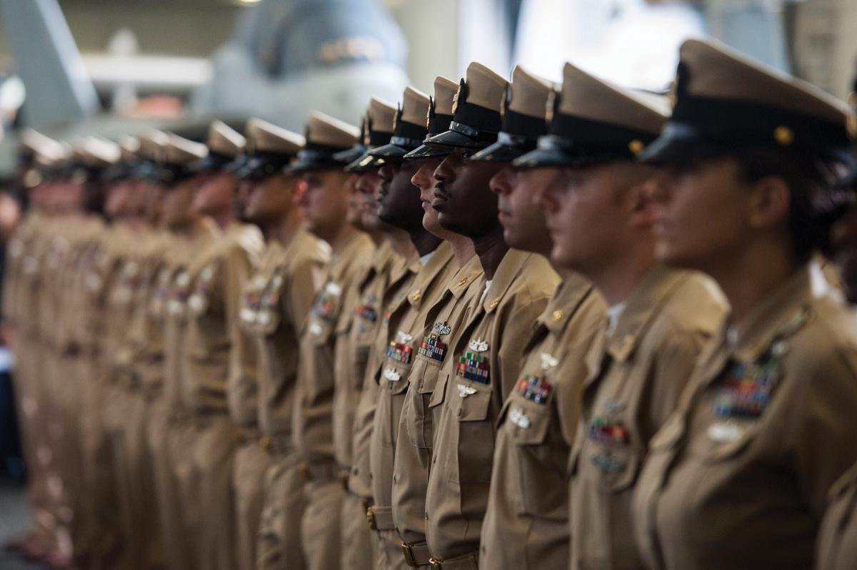 Fiscal Year 2017 chief petty officers stand at attention during a chief pinning ceremony aboard the aircraft carrier USS George H.W. Bush (CVN-77)