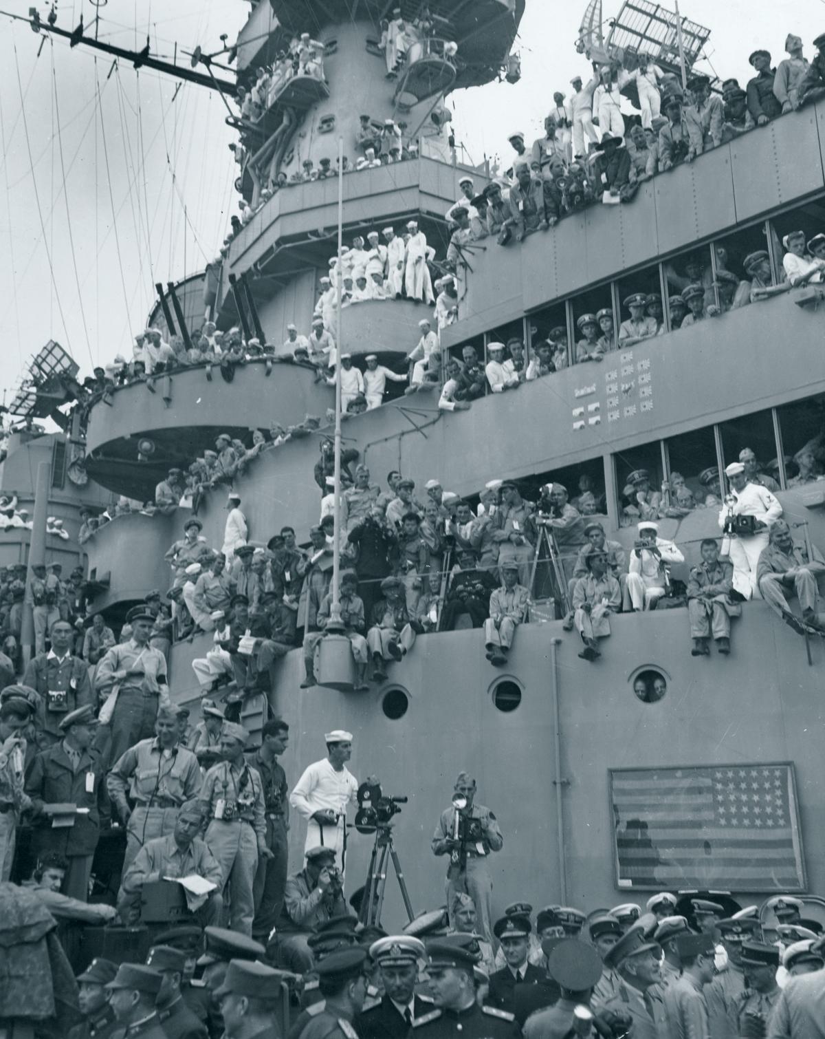 Front row seat to history: Sailors crowd the decks of the USS Missouri in Tokyo Bay to witness the formal Japanese surrender proceedings on 2 September 1945.