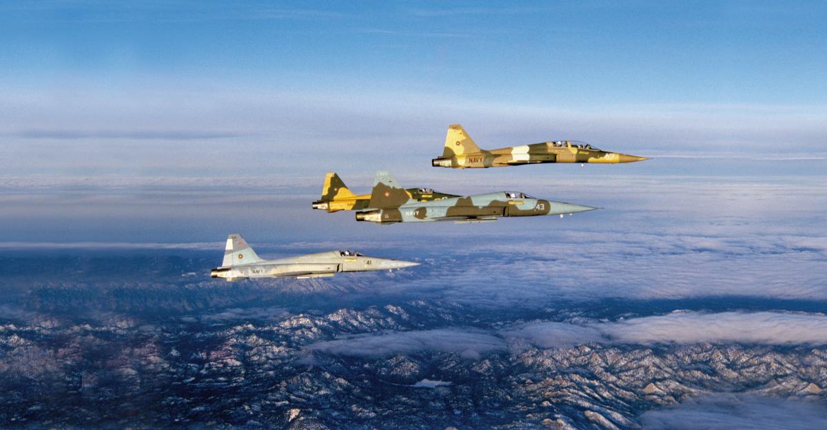 Four Navy Fighter Weapons School (TOPGUN) F-5s cruise above Southern California on the way to an early morning showdown with some F-14 Tomcats.