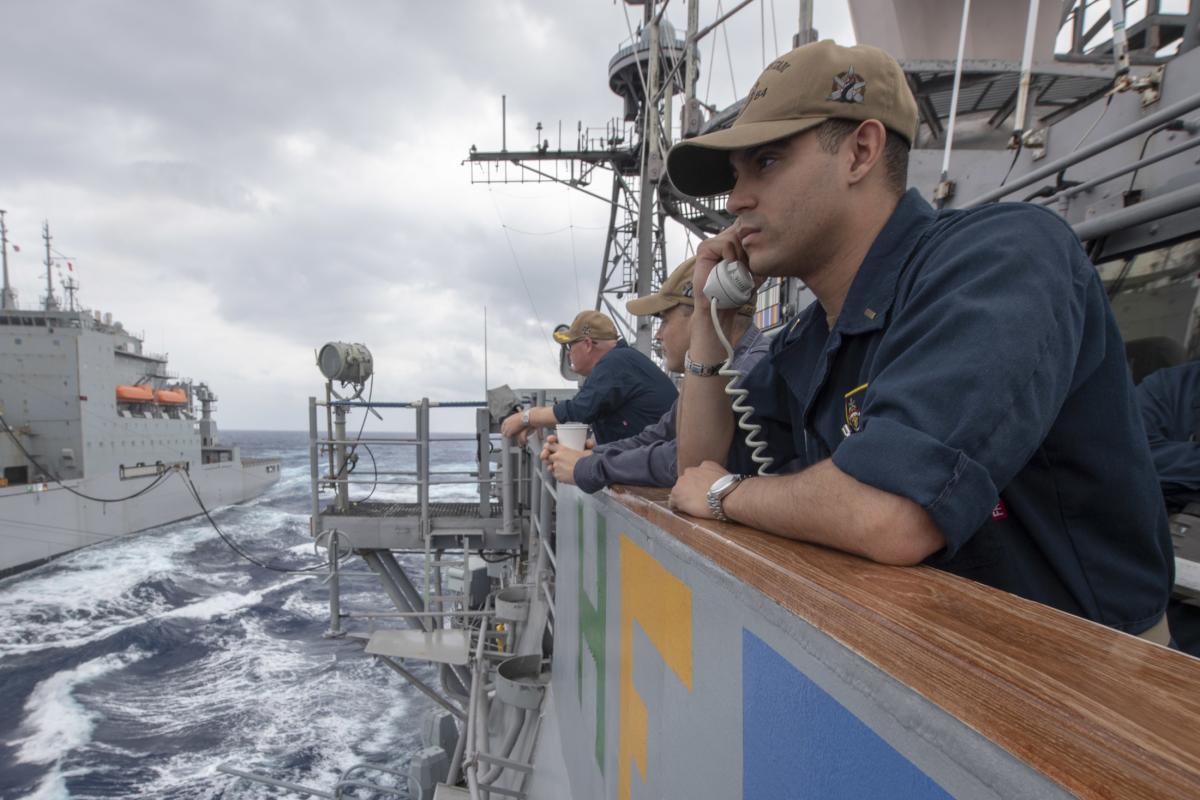 Ensign Morgen Richards stands communication watch on the bridge wing of the guided-missile cruiser USS Antietam (CG-54) during a replenishment-at-sea evolution.