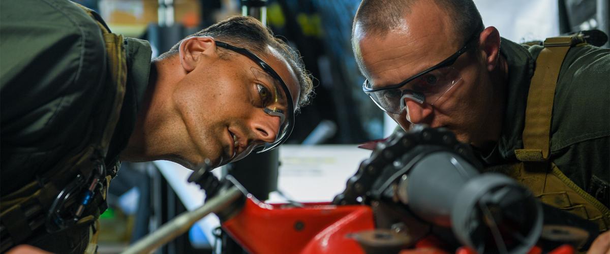 Marines with the Expeditionary Exploitation Unit one (EXU-1) analyze a foreign ordnanc