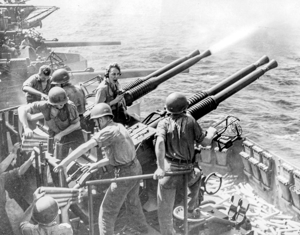 A gun crew on board the USS Hornet (CV-12) fires its quad-mount Bofors 40-mm in 1945