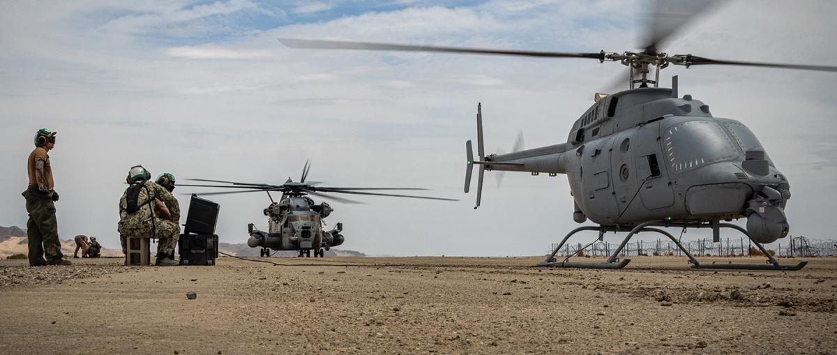 There is a precedent in naval aviation for integrating manned and unmanned aircraft. Here, a CH-53E Super Stallion refuels an MQ-8C Fire Scout unmanned helicopter.