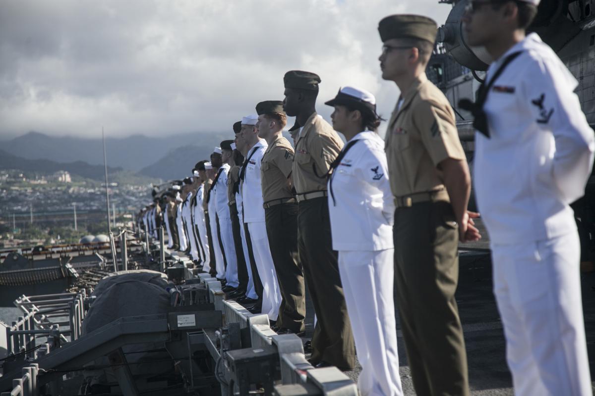 Sailors and Marines man the rails of the USS Essex (LHD-2) in Pearl Harbor, Hawaii.