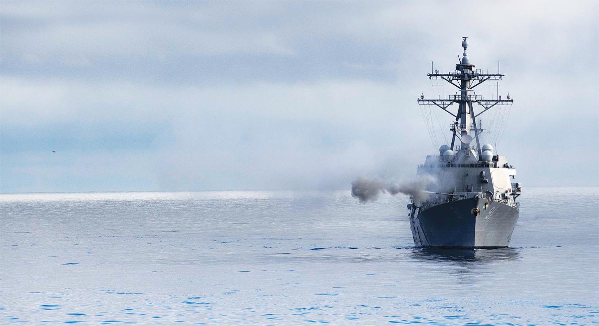 The USS Pinckney (DDG-91) fires her forward gun.