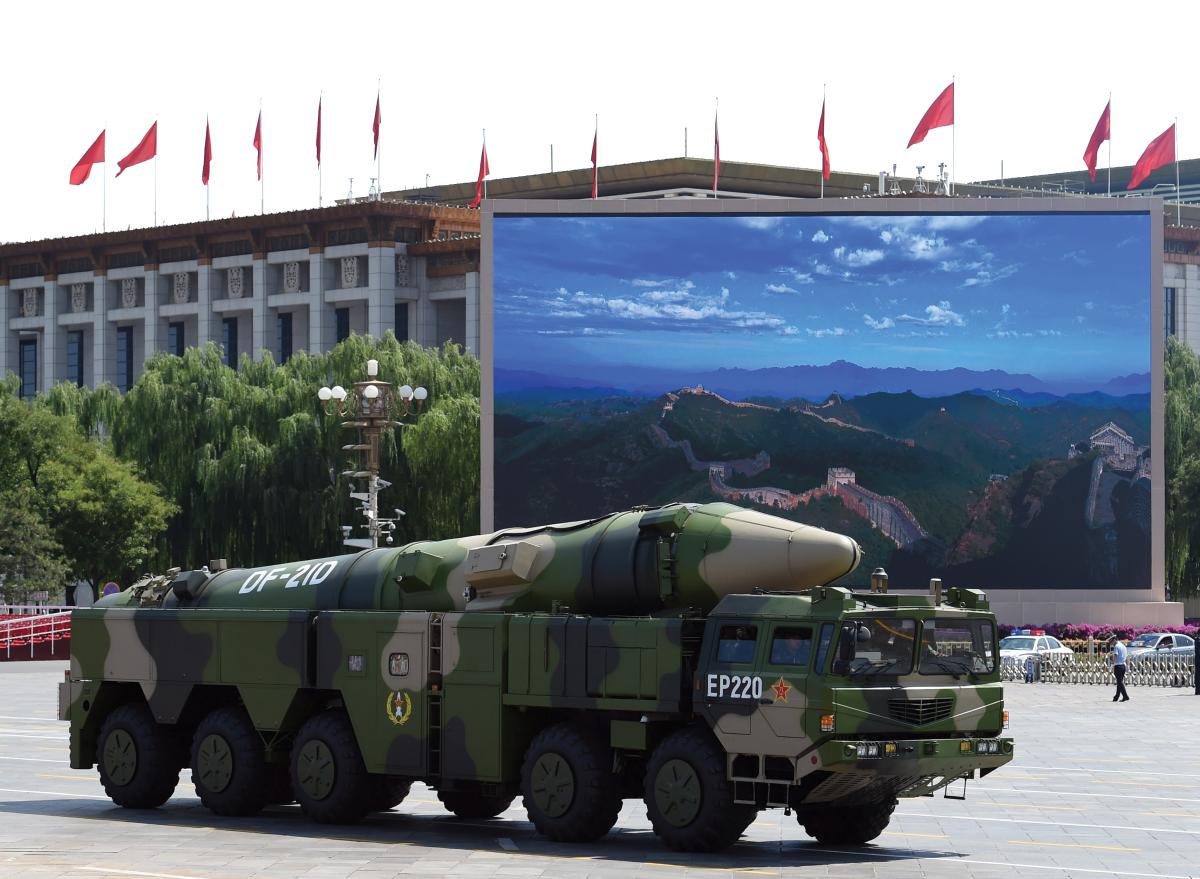 A military vehicle carries DF-21D missile past a display screen featuring an image of the Great Wall of China at Tiananmen Square in Beijing on September 3, 2015