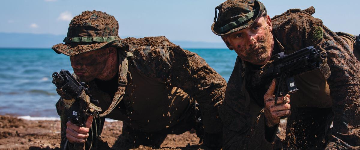 U.S. Marines assigned to a reconnaissance detachment prepare to move on an objective as part of amphibious operations training during an exercise in Lido Beach, Greece.