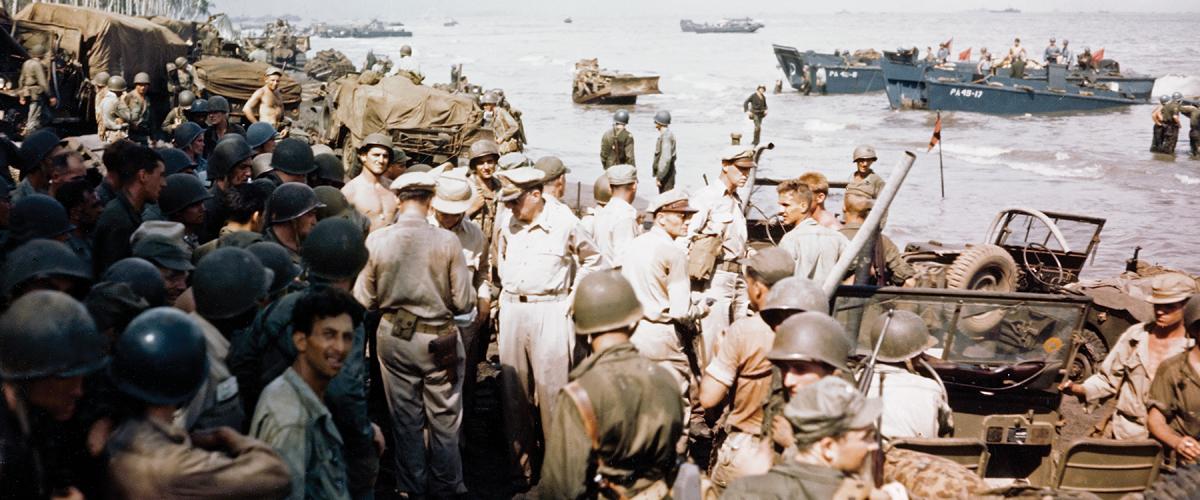 “I have returned.” General Douglas MacArthur (left center, hands on hips) inspects the beachhead on Leyte Island, 20 October 1944.