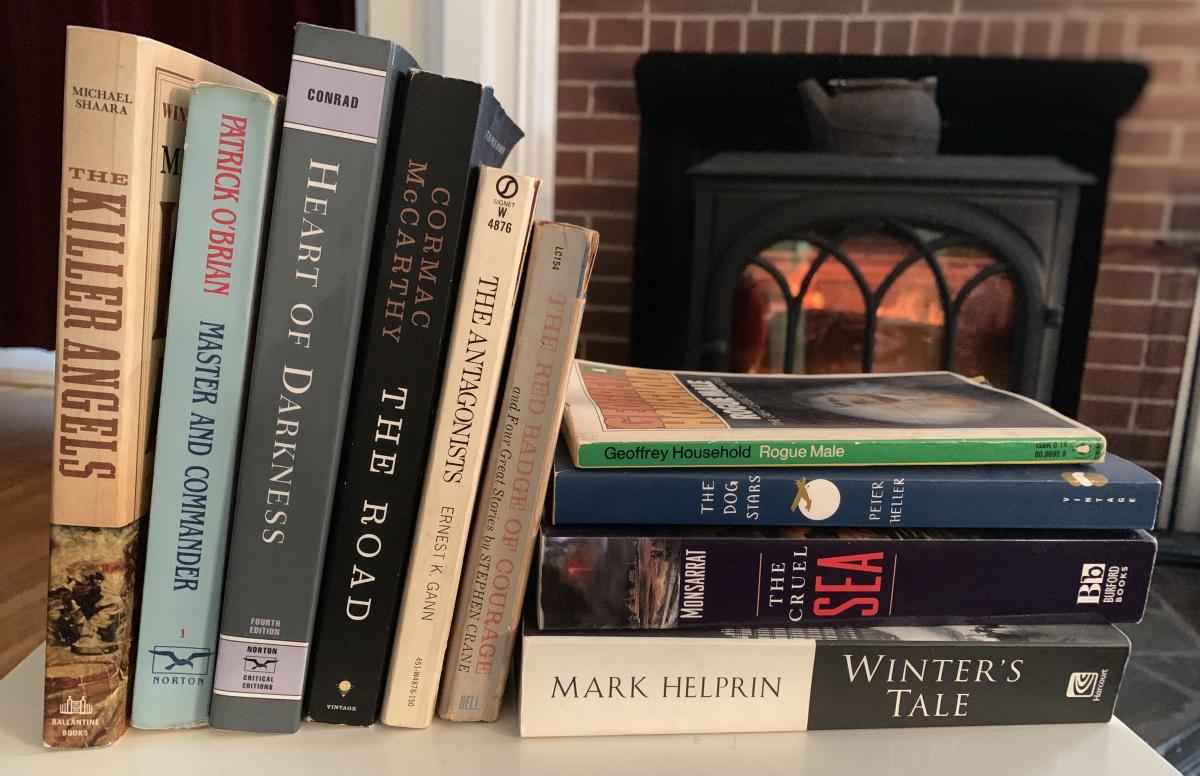Books on a table by a fireplace