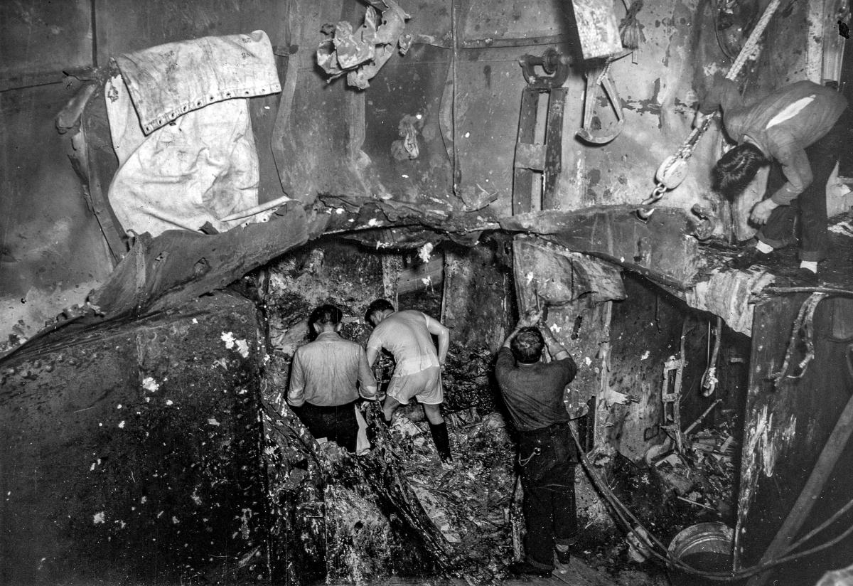 A repair party works in a hole made by a blast on the Yorktown's third deck.