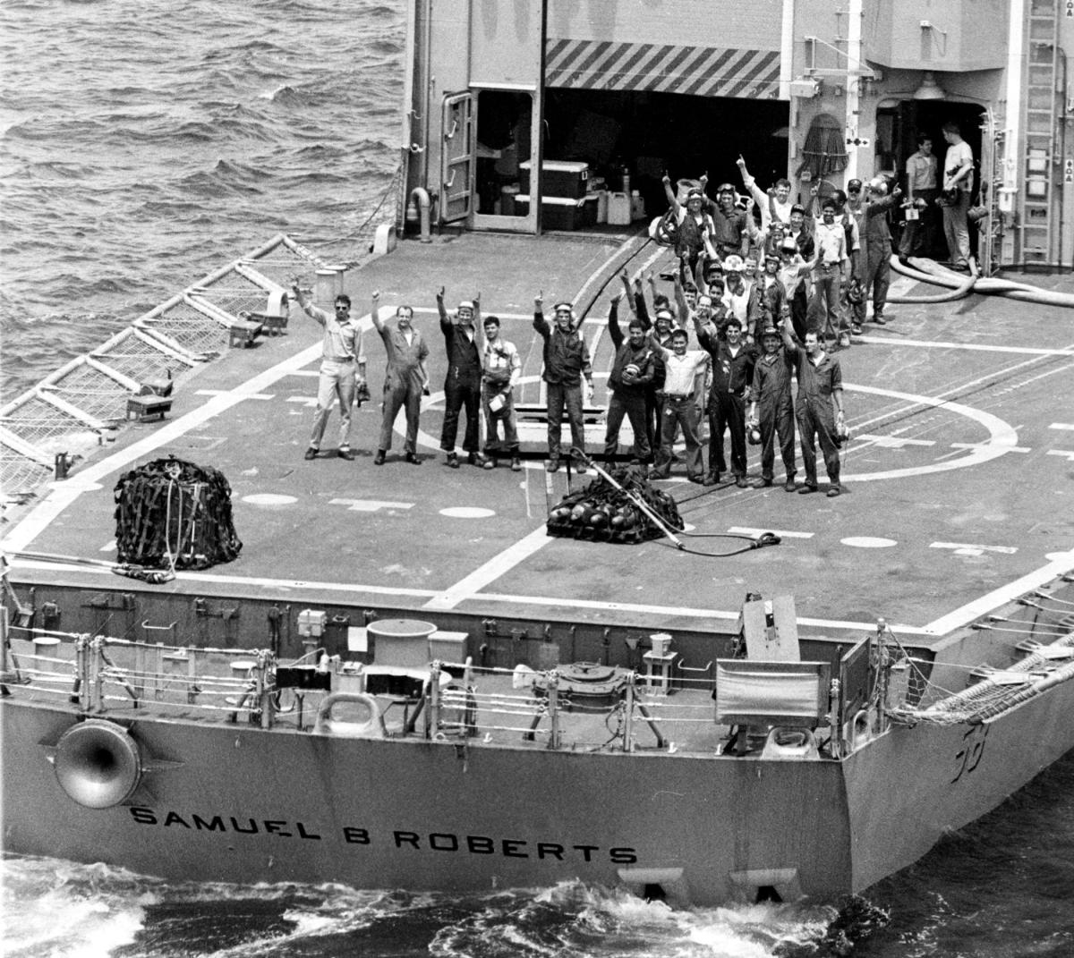 Sailors wave from the deck of the Samuel B. Roberts (FFG-58)