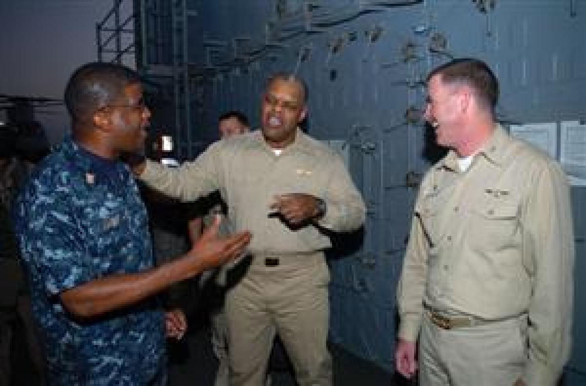 Providing honest feedback to all levels in the chain-of-command is a Chief's most important responsibility, the author says. Here, Rear Admiral Sinclair Harris (center), commander of Expeditionary Strike Group 5, speaks with Captain Kevin Couch, commandin
