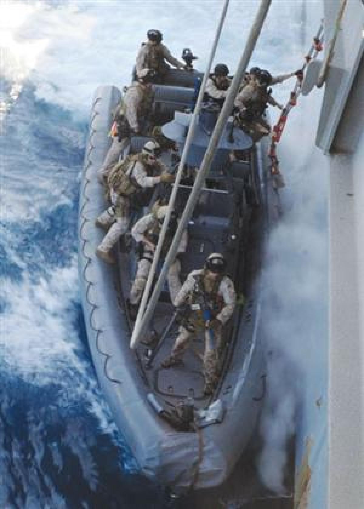 In its preparation for hunting pirates, the author's platoon trains for hook-and-climb tactics, having just completed the hook and starting to climb. At press time, the unit was en route to its first live mission. Marine Force Reconnaissance was reactivat