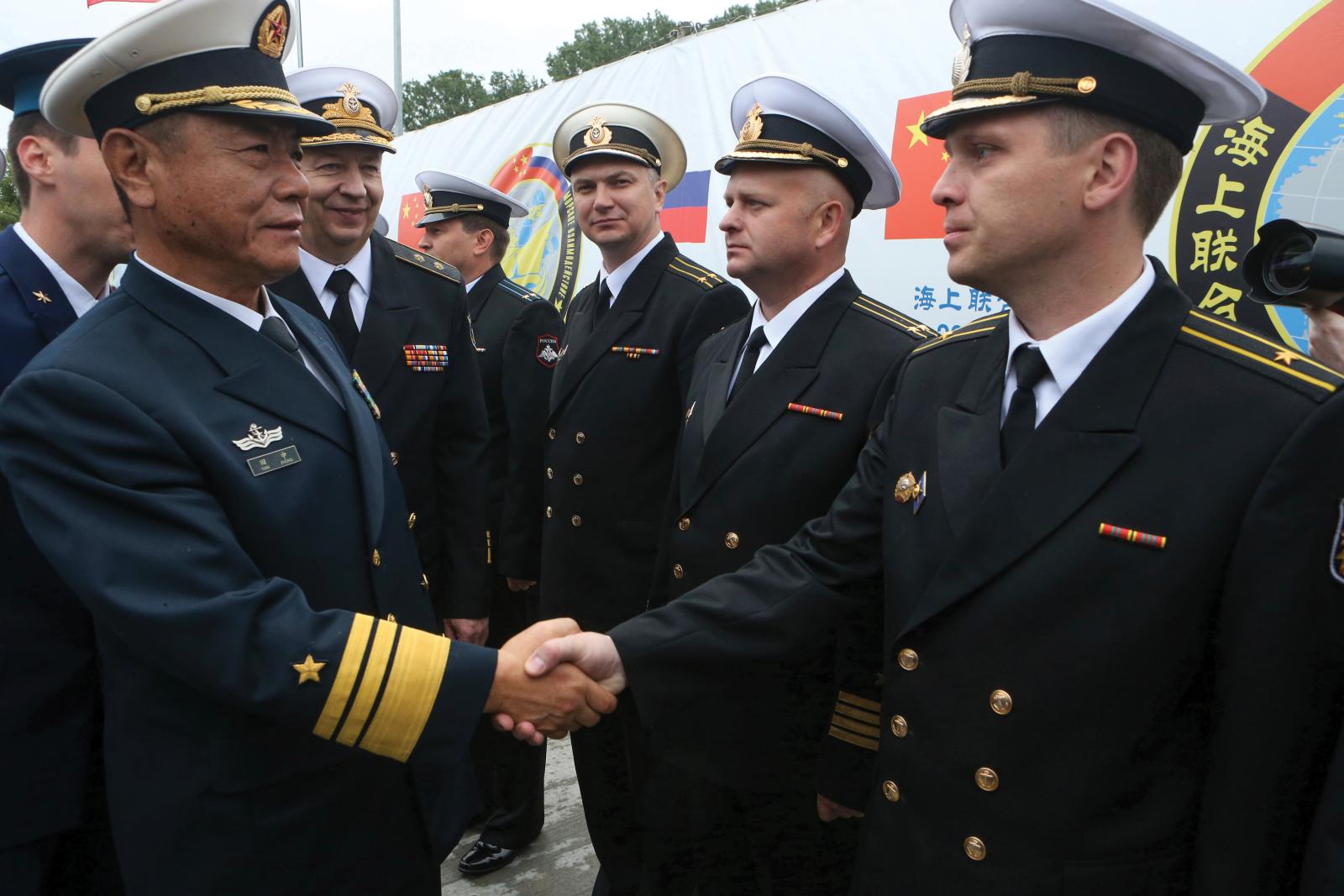 Chinese and Russian navy commanders greet each other