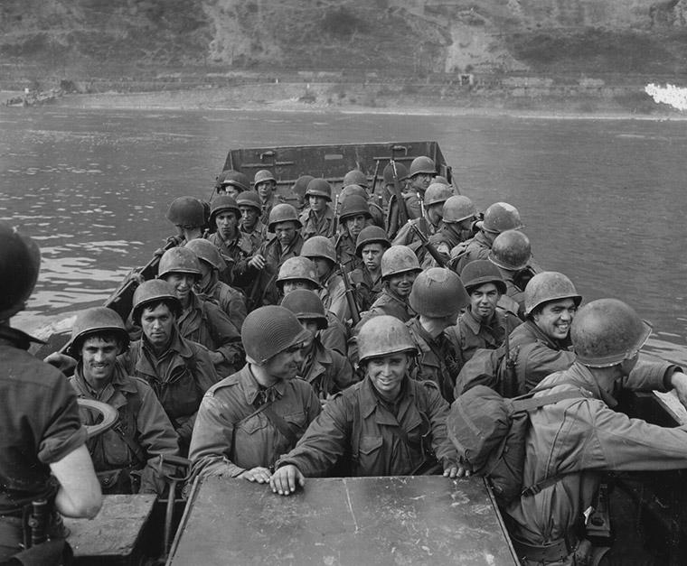 Ninth U.S Army infantrymen under enemy fire rapidly cross a pontoon footbridge 