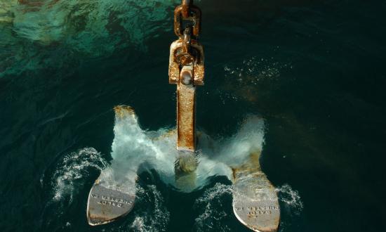 Anchor being hoisted from the sea