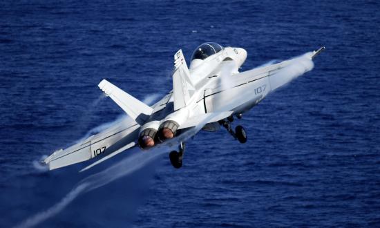 An F/A-18F Super Hornet from the "Black Knights" of Strike Fighter Squadron (VFA) 154 launches from the Nimitz-class aircraft carrier USS John C. Stennis (CVN-74)