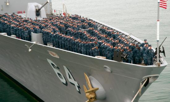 Sailors aboard the guided-missile cruiser USS Gettysburg (CG 64) salute during a command photo on the forecastle. 