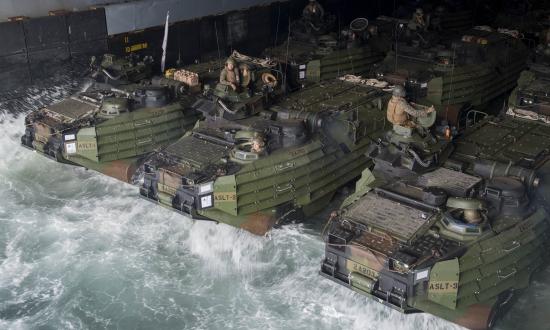 Marines and sailors, assigned to the 26 Marine Expeditionary Unit, stage amphibious assault vehicles in the well deck of the USS Oak Hill (LSD-51).