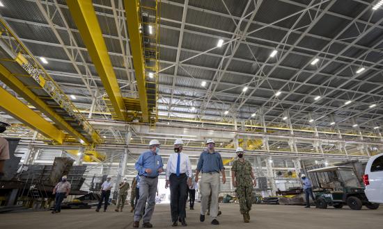 Secretary of the Navy Kenneth Braithwaite tours the Huntington Ingalls Industries shipyard in Pascagoula, Mississippi. The visit was one in a series to discuss industrial base economic wellness—a critical factor should the United States need to mobilize for major conflict.