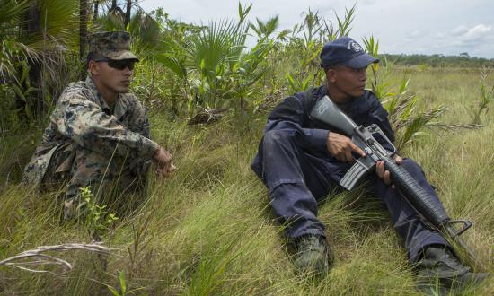 U.S. Marine Corps Cpl. Jorge Flores advises Seaman Apprentice, Belize Coast Guard, Nue Hernandez.