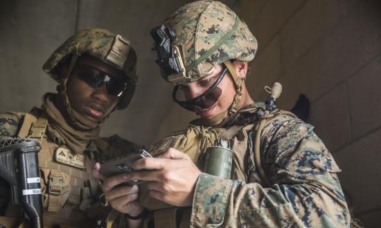 Marines look at mobile phone