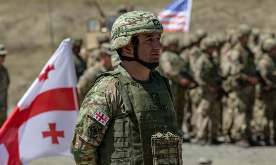 Military personnel from Georgia and the United States stand in formation during the closing ceremony of Agile Spirit 19 at Orpholo Training Area, Georgia, in August 2019. Personnel from 14 countries participated in the Georgia-NATO exercise.