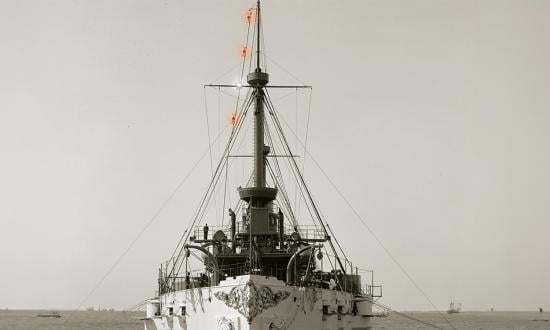The USS Texas, built in 1892, is shown here in about 1895. In the rigging of the foremast on the ship’s starboard side can be seen four evenly spaced lamps of an Ardois system. The lamps can show various combinations of red and white lights, employing a coded system to pass messages quickly and at considerable distances, even at night or in low-visibility conditions.