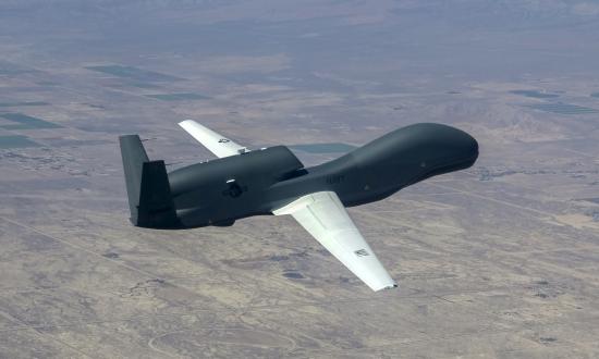 Aerial oblique right rear view of an MQ-4 Triton drone in flight