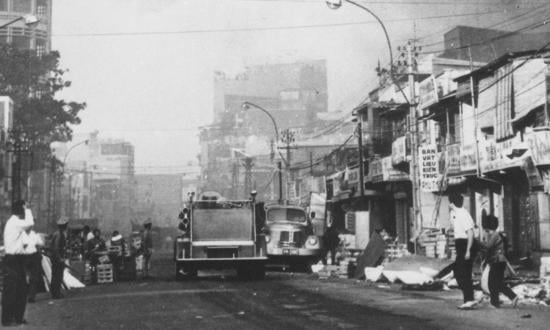 Black smoke billows over Saigon during the 1968 Tet Offensive. Admiral Veth (inset) said of the U.S. media coverage, “I think the reporting was just plain miserable.”