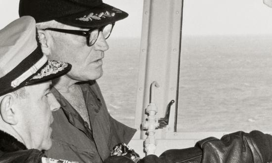 Vice Admiral John J. Hyland explains the main function of the primary flight control system to Barry Goldwater during his 18 January 1967 visit to the attack aircraft carrier USS Kitty Hawk (CVA-63) in the Tonkin Gulf.