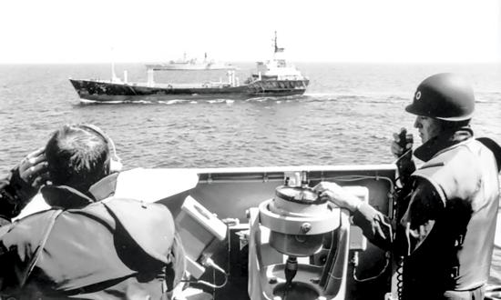 The Royal Australian Navy Adelaide-class guided-missile frigate Darwin intercepts the Iraqi motor vessel Tamdur smuggling prohibited goods in the Gulf of Oman, September 1990.