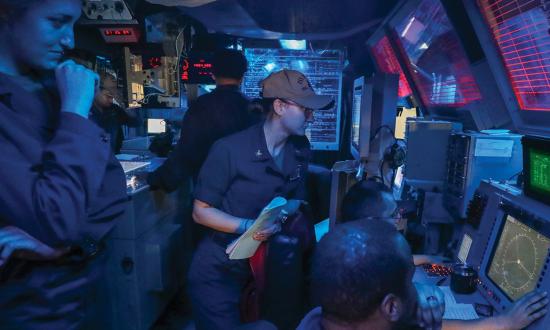 Sailors in the combat information center of the Arleigh Burke–class guided-missile destroyer USS Higgins (DDG-76) operating in the Philippine Sea.  
