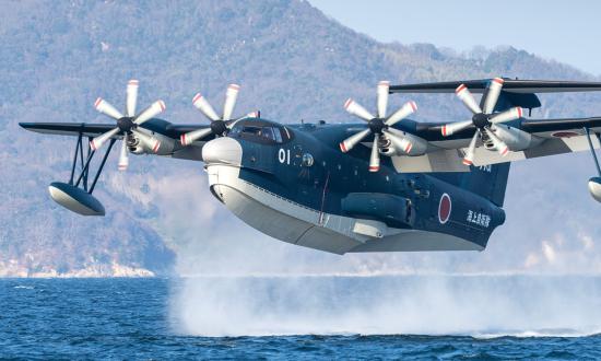 An amphibious transport aircraft, a Japan Maritime Self-Defense Force ShinMaywa US-2, lands on the water at Marine Corps Air Station Iwakuni, Japan, in January 2023. 