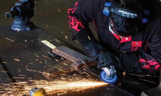 A steelworker grinds out a metal strip in preparation for welding.  The maintenance community should embrace truthful reporting, both because it will increase unit cohesion and because it could lead to improved timelines for meeting milestones. 