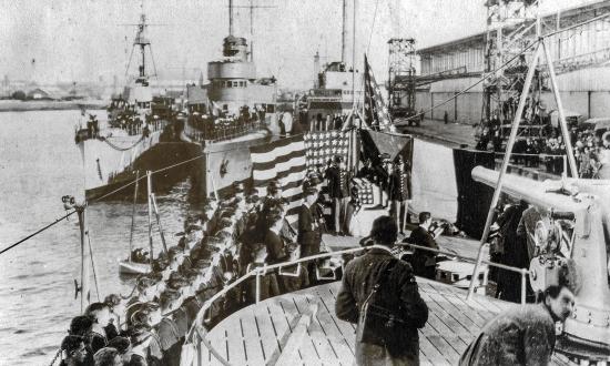 A ceremony on board the USS Olympia (C-6) as part of the transportation of the body of the  “unknown soldier” from France to the United States in 1921.