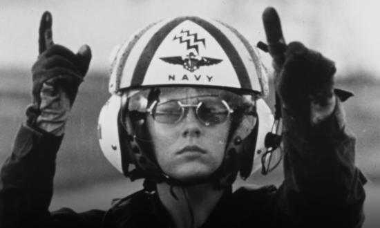 Dianna Heath signals the pilot of a UH-1N Iroquois helicopter