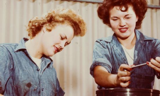 WAVES Seamen Second Class Elaine Olsen and Ted Snow learn to take down a radial aircraft engine block at Naval Air Station Lakehurst during World War II.