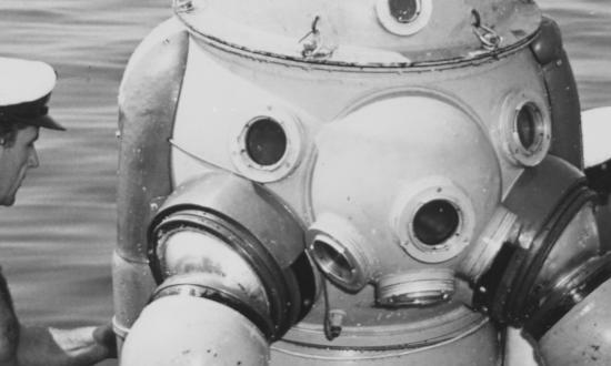 Take her down! Divers on board the Proteo prepare to lower away a fellow deep-sea diver in the ship’s 800-pound armored diving suit.