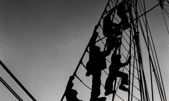 U.S. Coast Guard cadets scale a shroud on board the USCGC Eagle (WIX-327)
