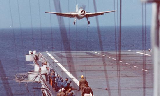 A Grumman TBF Avenger lands on board the USS Charger (CVE-30) during flight training operations in the Chesapeake Bay area, 22 April 1944.