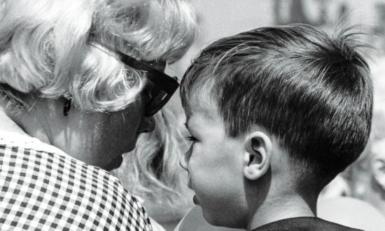 Woman talking to a boy wearing a sailor suit