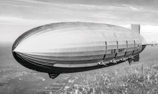 USS Macon (ZRS-5), is shown in flight over lower New York City