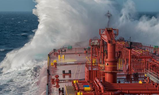 A wave breaks against a tanker ship. Knowing where Russia is engaged in illegal oil revenues is paramount to avoiding further illicit activities and preventing potential escalation of oil smuggling—and even possibly potential military maneuvers.