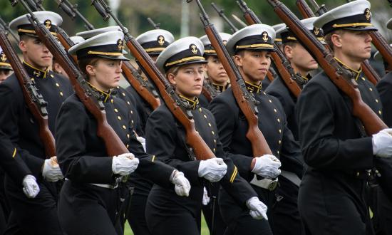 Midshipmen from the U.S. Naval Academy take part in a formal parade. A Naval Academy education produces not only officers who will continue to grow into their responsibilities, but young men and women who will become leading citizens during and after their uniformed service.
