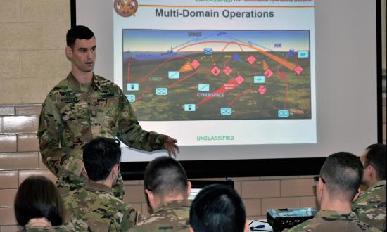 An Army IO officer briefs soldiers