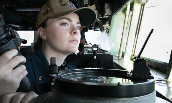 A Navy lieutenant stands watch. If the Navy wants to fill its department head, executive officer, and commanding officer billets, it needs more women—who separate sooner and at a higher rate than men—to commit to longer careers in the service.