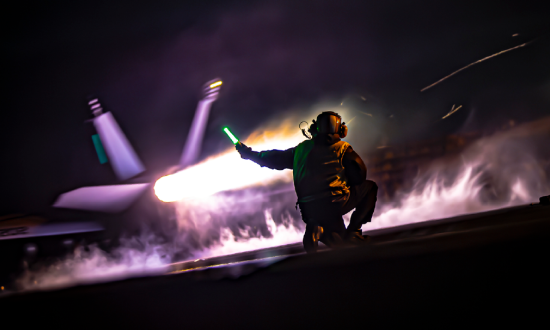 Personnel guiding an aircraft landing.