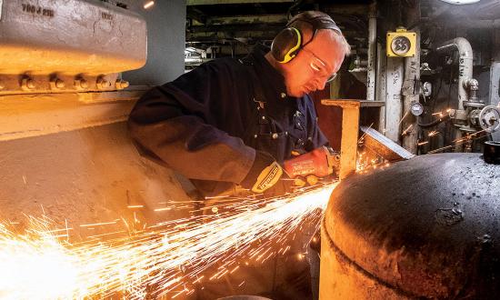 A damage controlman patches an oil filter pot in the engine room of the USCGC Polar Star (WAGB-10) while underway in the Southern Ocean. The Coast Guard must cultivate and preserve among its members within the service  the engineering skills and knowledge required to maintain its fleet while at sea and in port. 